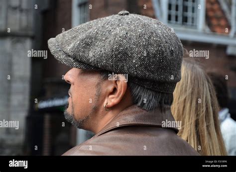 man wearing newsboy cap.